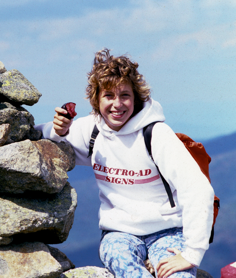 Talie sitting on a mountain when she was a teenager.