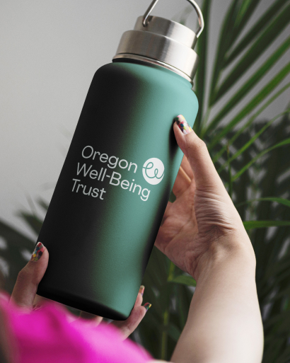 Person holding Oregon Well-Being Trust green water-bottle.