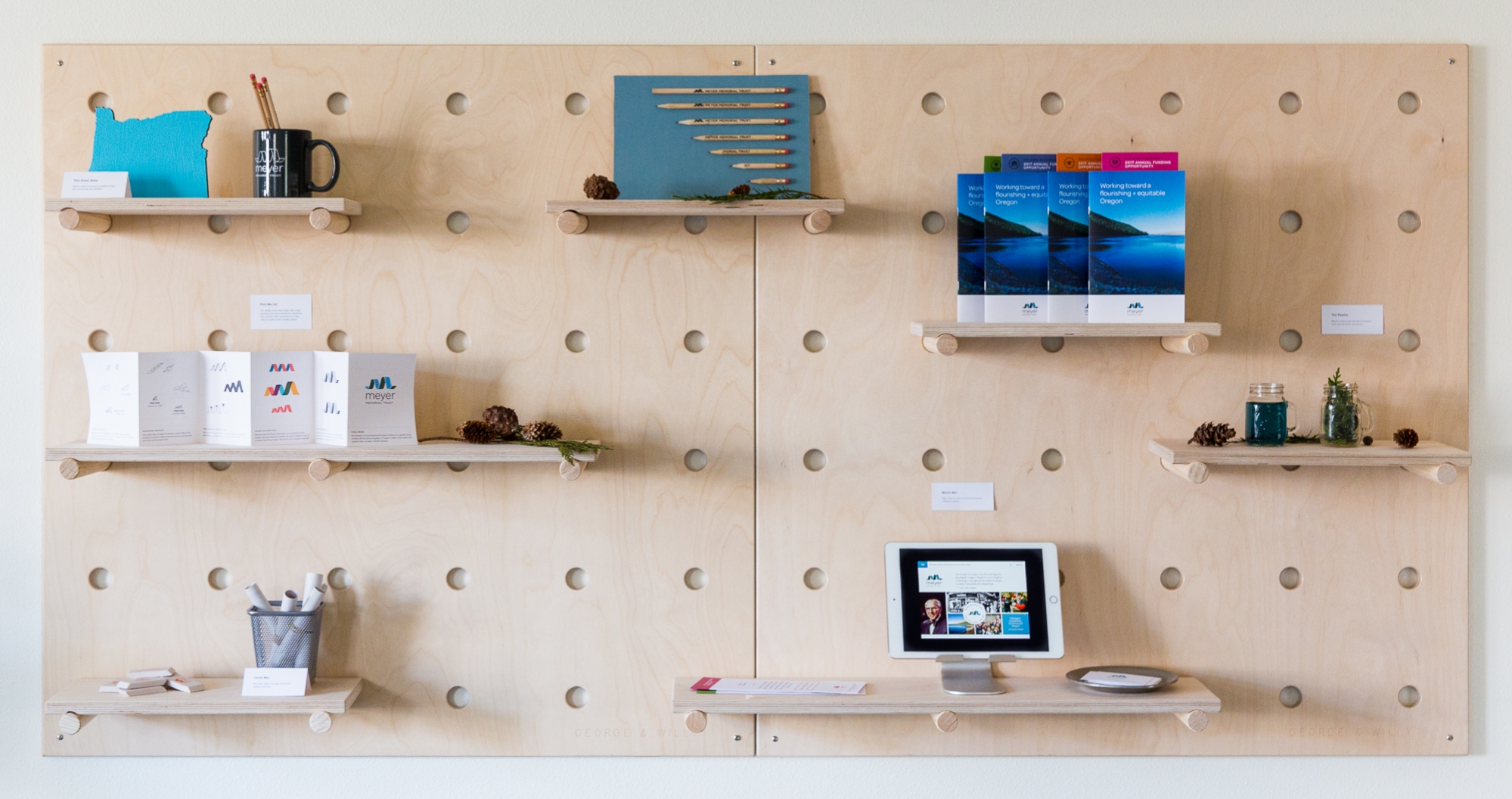 Large pegboard displaying Meyer Memorial Trust marketing materials.