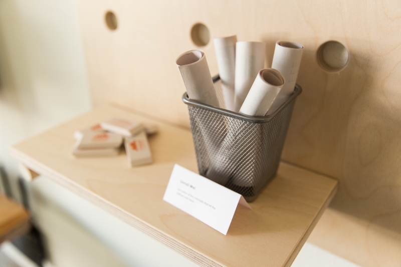 Small wire basket containing paper scrolls.