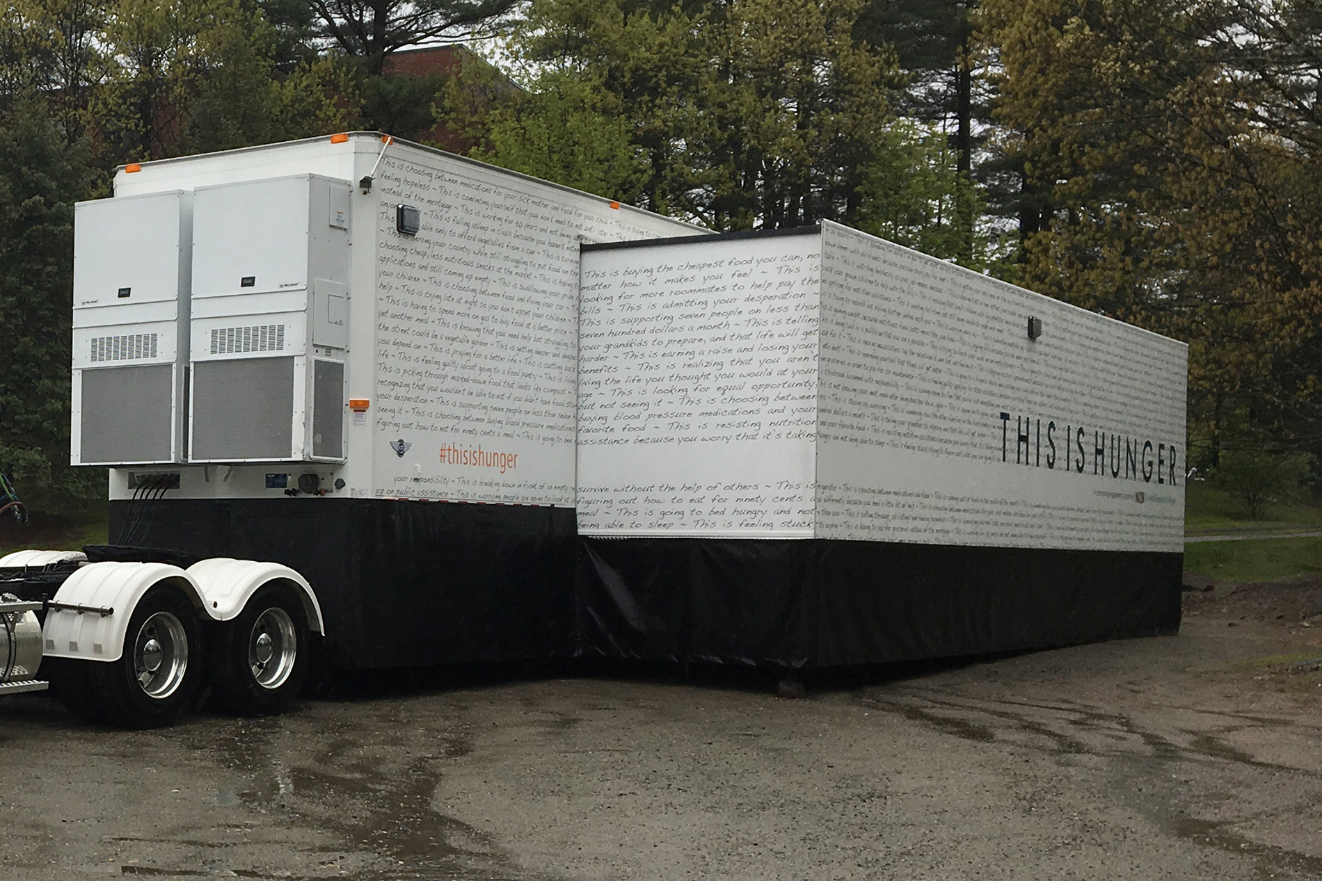 Image of expandable truck with word this is hunger on it's side.