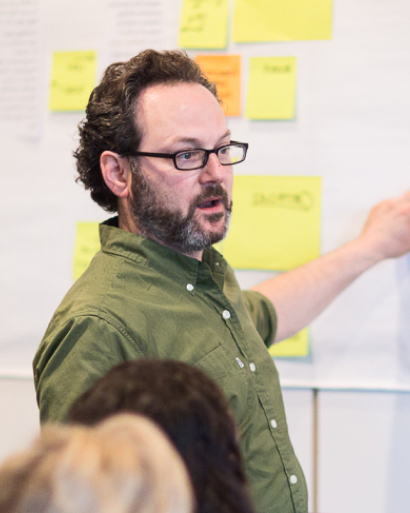 Scott talking and presenting from a board.