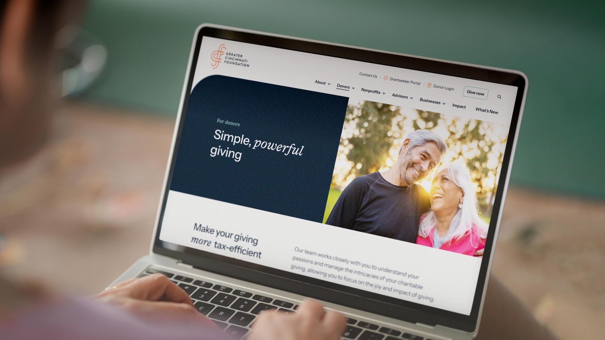 View of a person using a laptop to browse the Greater Cincinnati Foundation website.