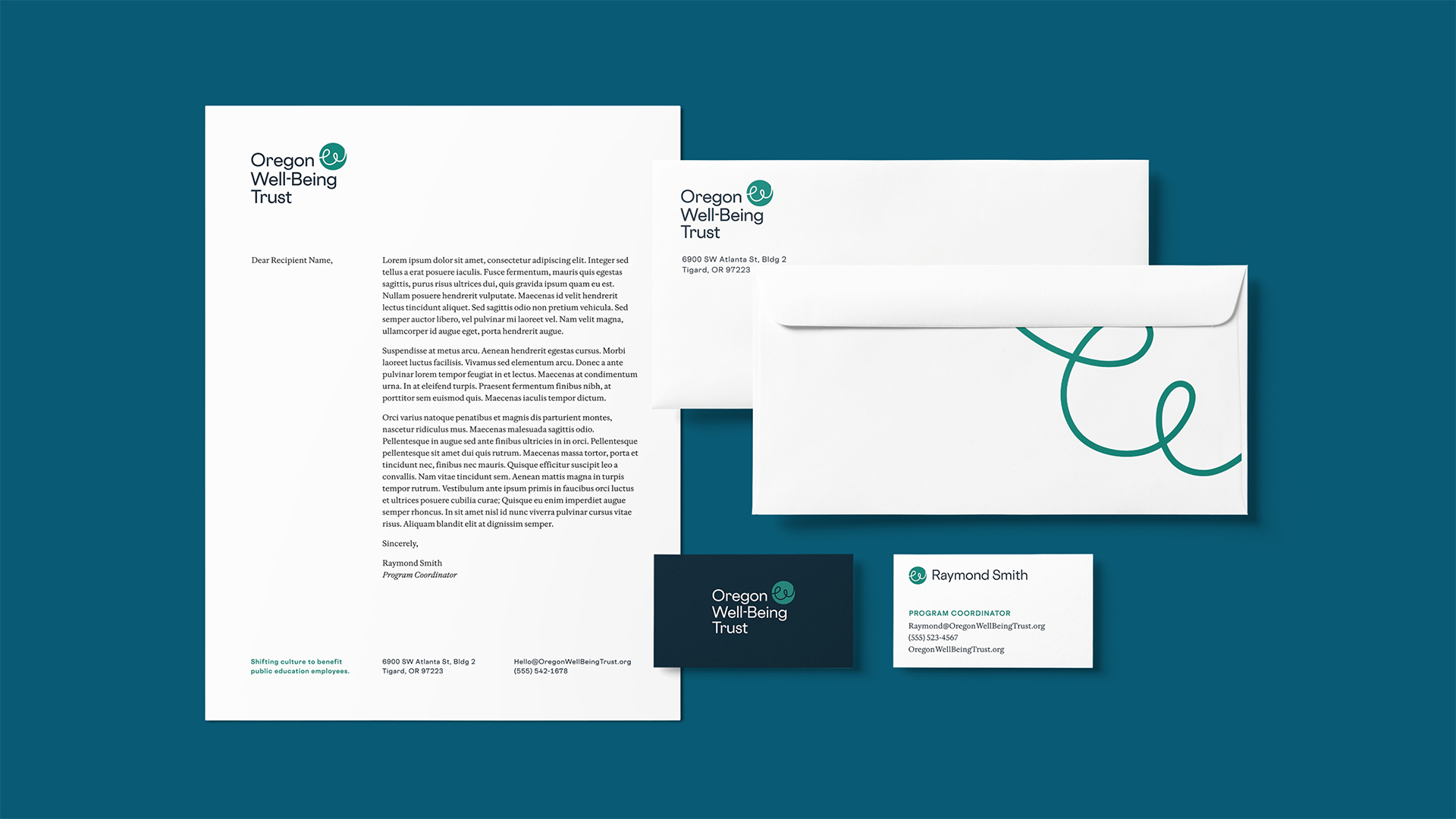 A flat lay of stationary designs that are simplistic and include the new OWT logo.