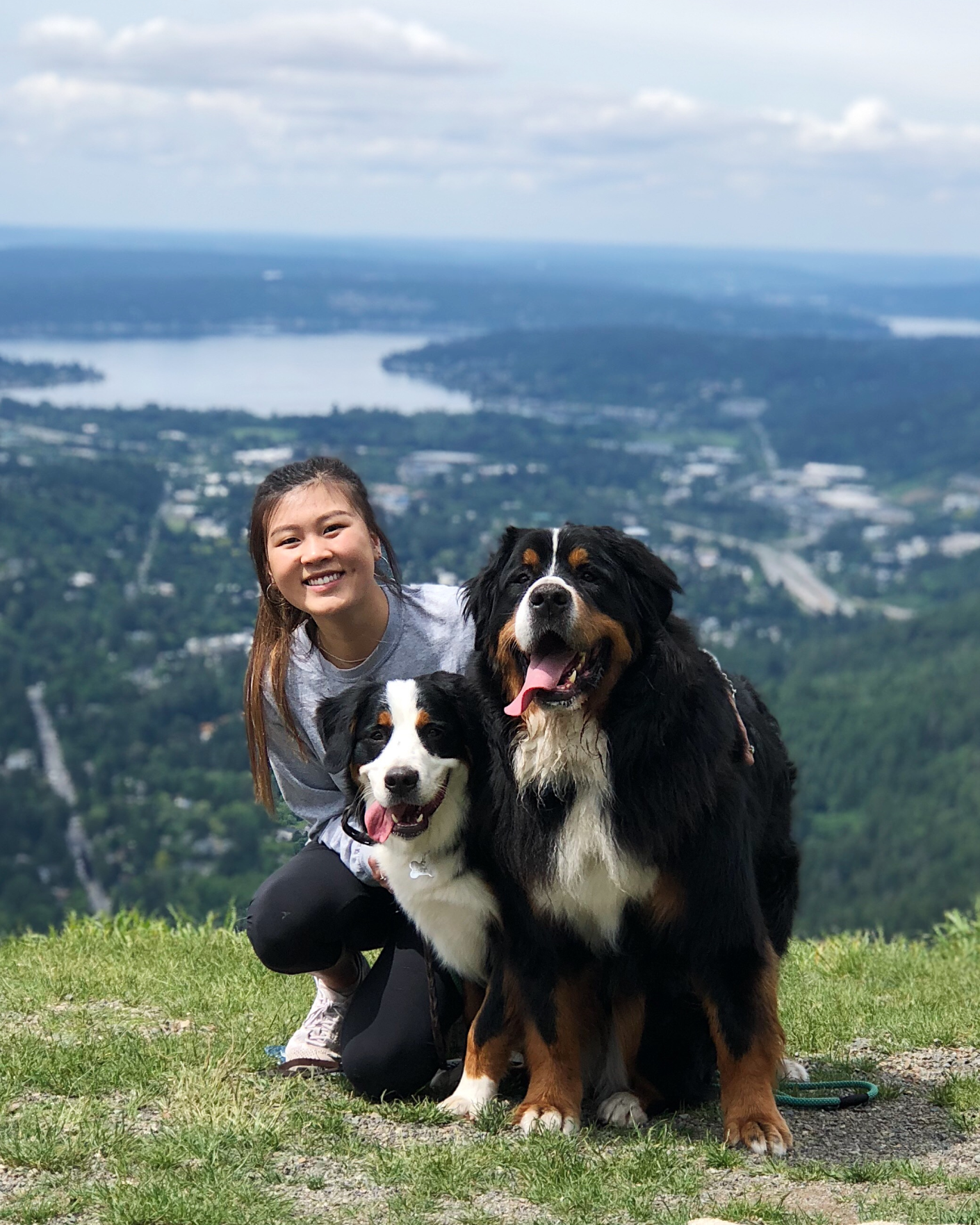 Kathryn and two dogs on a mountain top
