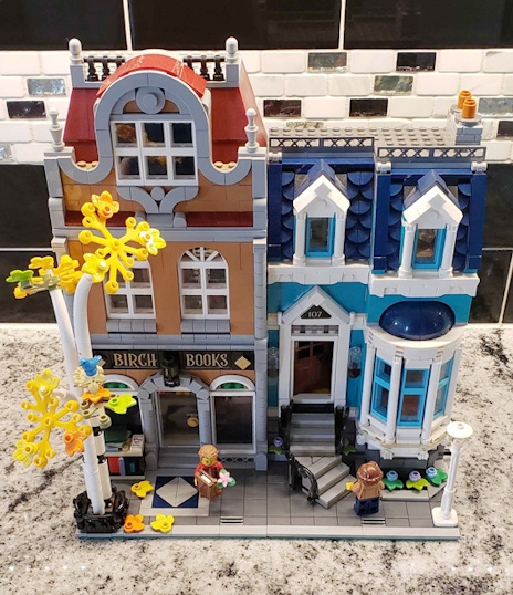 Two townhouses made out of Lego bricks, with a quaint bookshop on the ground floor.