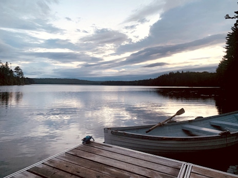 Photo of a dock and lake in Maine at dusk.