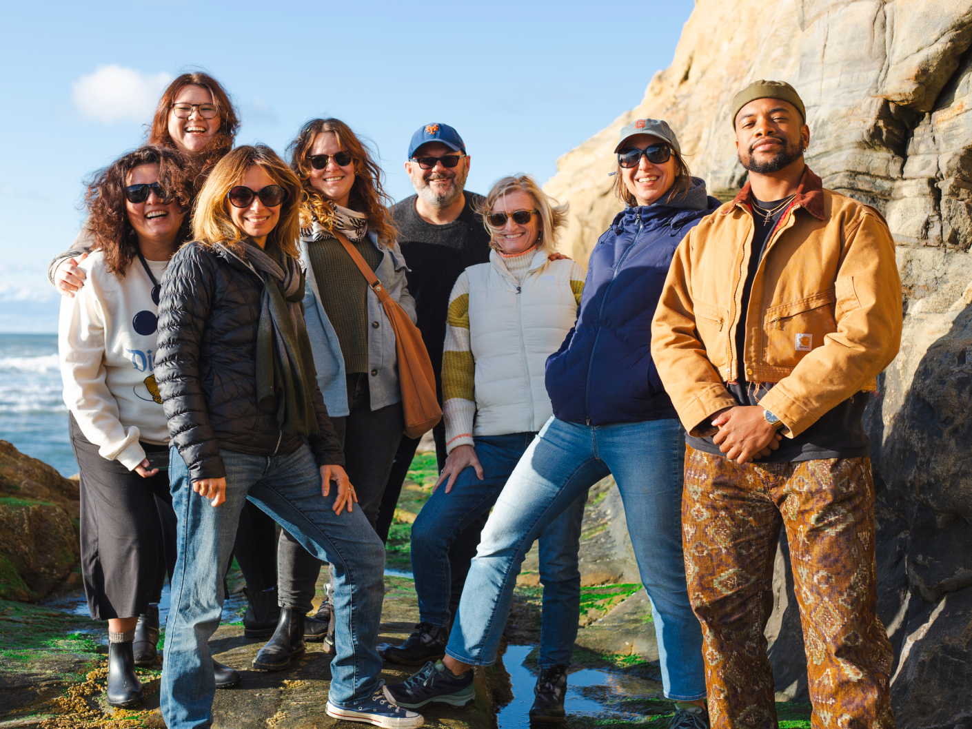 The S&C team standing together for a photo on the beach during a team retreat