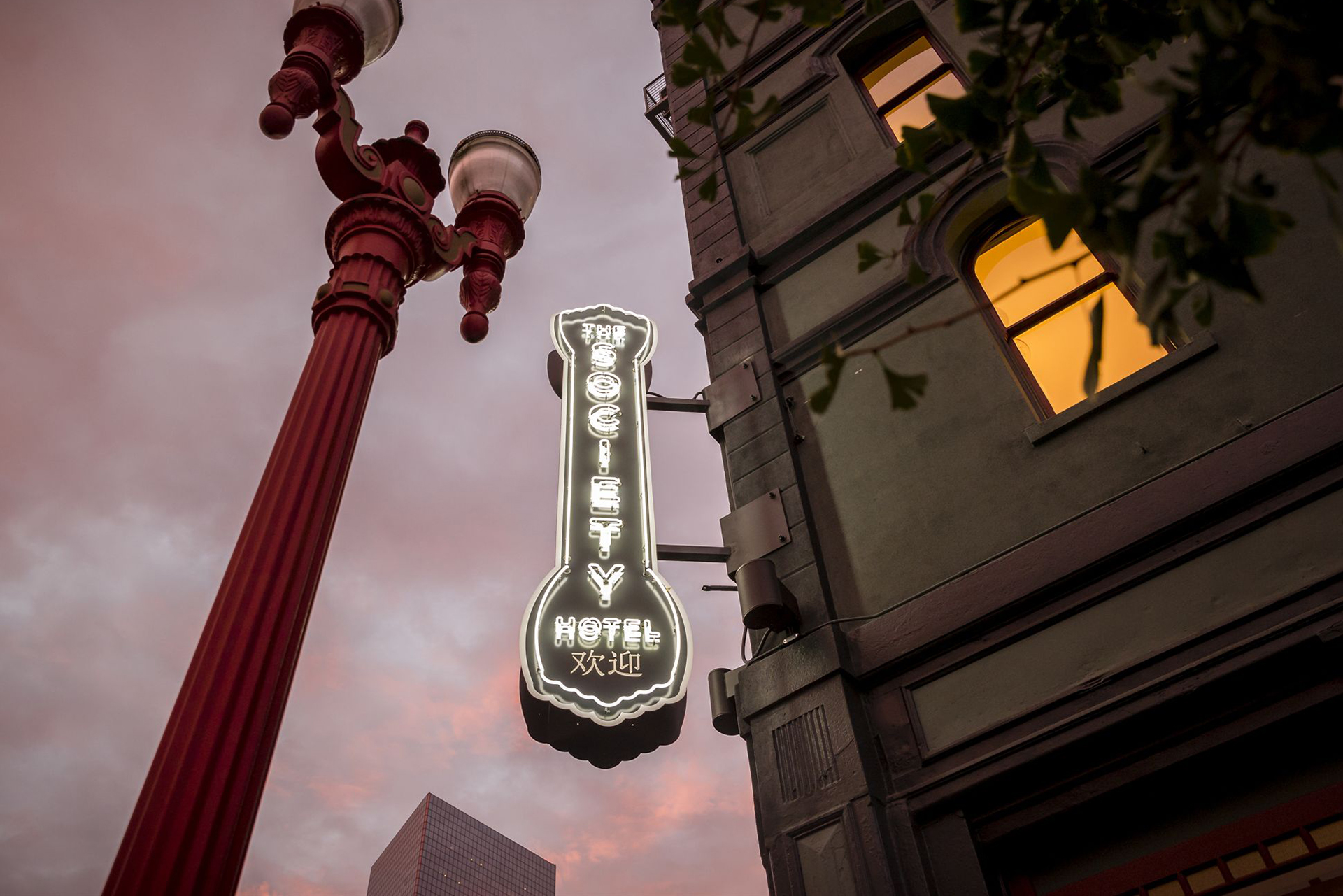 Street view image of The Society Hotel looking up at their sign.