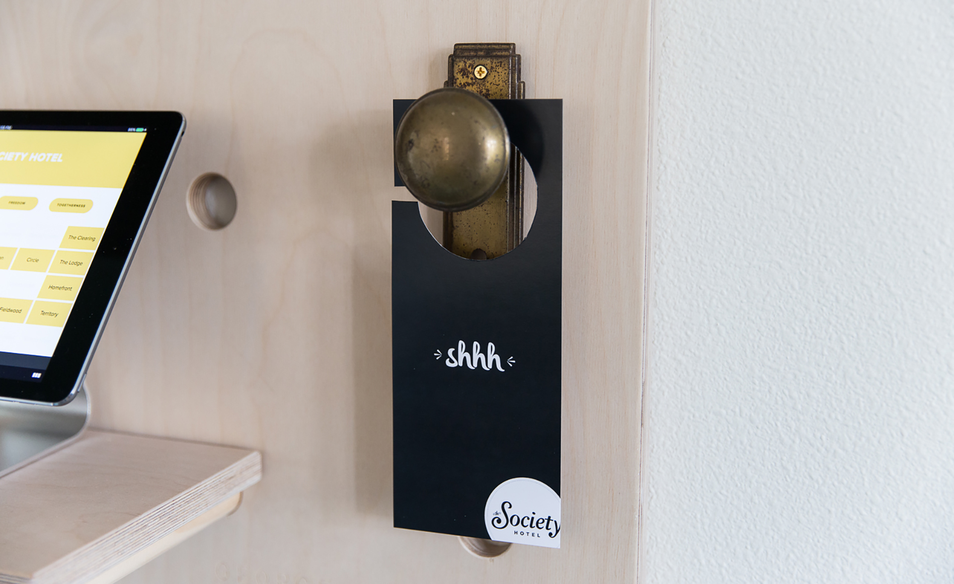 A "shhh" sign on the room door.