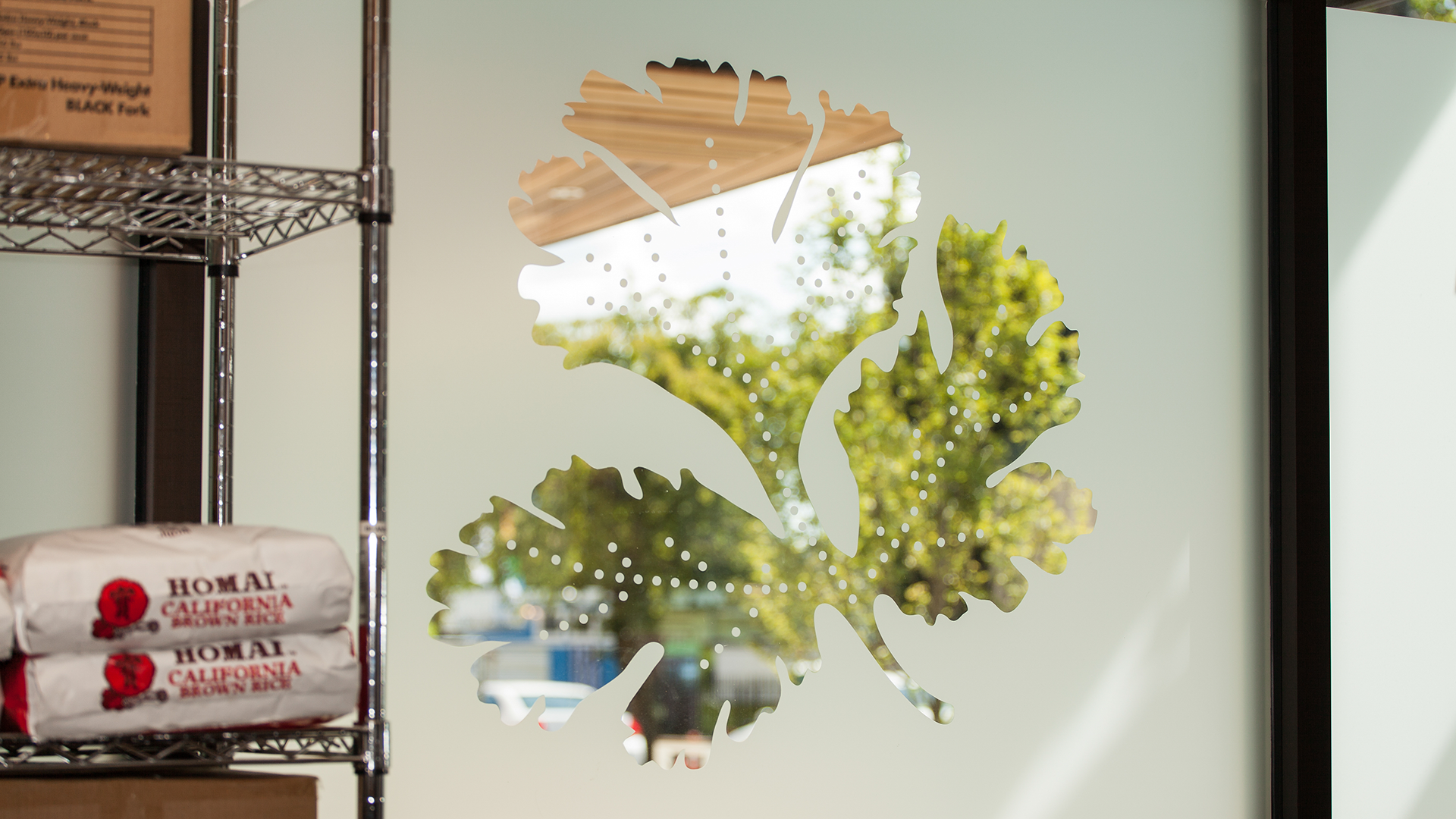 A cilantro leaf window decal in the restaurant made with frosted glass.